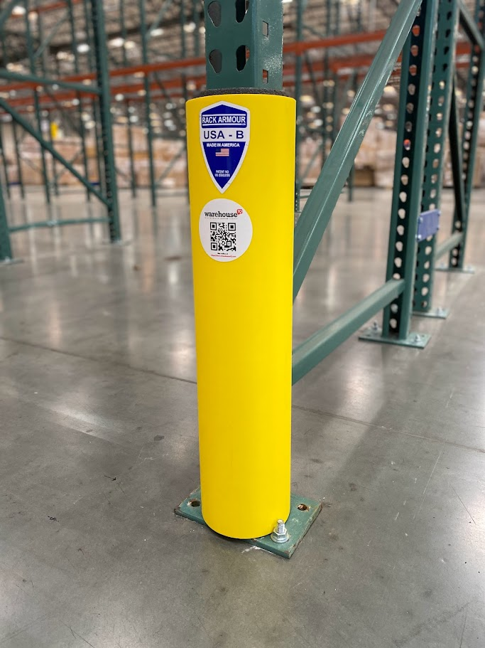 a yellow rack protector in the middle of an Orange County warehouse protecting pallet racking